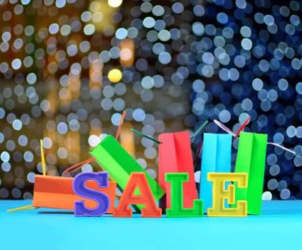 Sale written by colorful letters on the background of shopping bags Stock Photos
