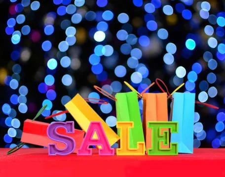 Sale written by colorful letters on the background of shopping bags Stock Photos