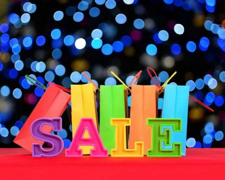 Sale written by colorful letters on the background of shopping bags Stock Photos