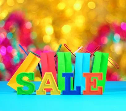Sale written by colorful letters on the background of shopping bags Foto stock