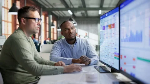 Sales Analyst Discusses CRM Software Features While Working Stock Footage 345851632