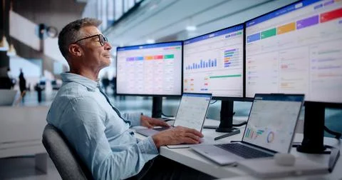 Sales Analyst Studies Customer Data On Laptop To Improve Sales Strategy. Stock Photos