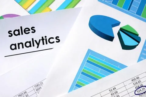 Sales analytics written in a document and business charts. Stock Photos