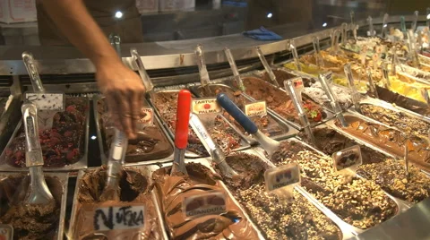 Sales assistant scooping out chocolate mousse, rome Stock Footage 59665364
