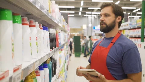 Sales clerk with digital tablet doing a stocktake in household store Stock Footage 92208161
