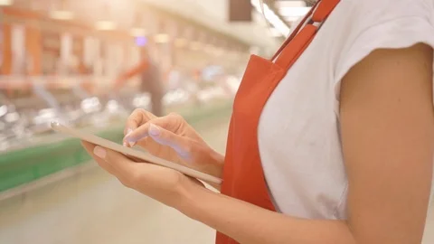 Sales clerk using digital tablet and doing a stock take in store Stock Footage 107456401