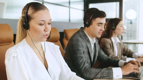 Sales consultants engage in client support activities at a modern office call Stock Footage 320911386