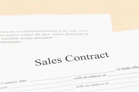 Sales contract on desk; document is mock-up Stock Photos