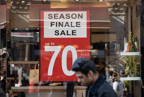 Sales is in front of the store. Stock Photos