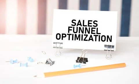 Sales funnel optimization sign on paper on white desk with office tools. Bl.. Stock Photos