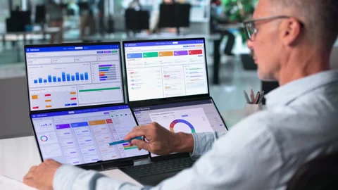 Sales Manager Analyzing Customer Data On Dual Touchscreen Laptops Stock Footage 344711331