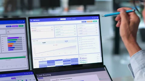 Sales Manager Analyzing Customer Data On Dual Touchscreen Laptops Stock Footage 344711669