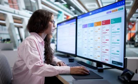 Sales Manager Analyzing Customer Data Using CRM Software On Computer. Stock Photos