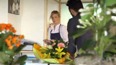 Sales manager at counter and client shopping in flowers shop Stock Footage