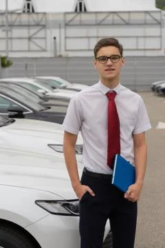 Sales manager with notepad is presenting or car trading. Motor show. Image of Stock Photos