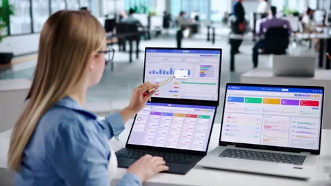 Sales Manager Reviewing CRM Data On Dual Touchscreen Laptops Stock Footage 343885796