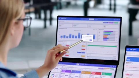 Sales Manager Reviewing CRM Data On Dual Touchscreen Laptops Stock Footage 344712423