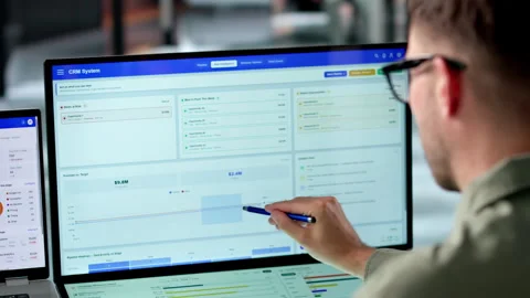 Sales Manager Reviews Customer Data Using CRM Software Stock Footage 339890703
