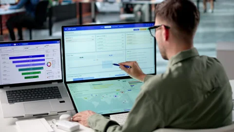 Sales Manager Reviews Customer Data Using CRM Software Stock Footage 340398120