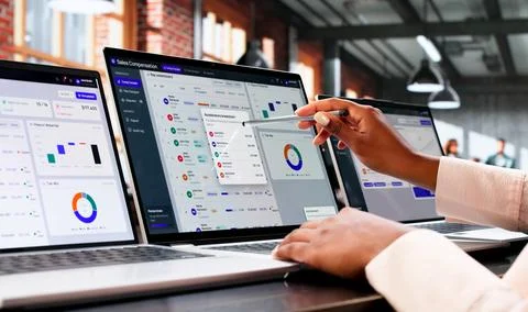 Sales Manager Studies Commission Dashboard On Laptop Tracking Team Sales Data Stock Photos