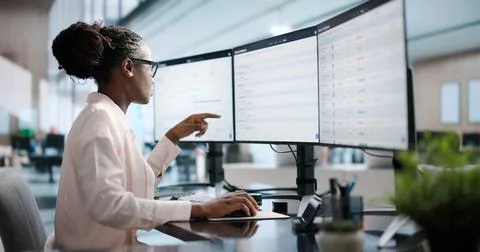 Sales Manager Studies Pipeline Data On Computer To Improve Revenue Growth. Stock Photos