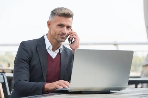 Sales manager talk to client on mobile phone using computer technology for Stock Photos