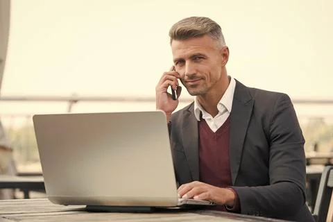 Sales manager talk to client on mobile phone using computer technology for Stock Photos