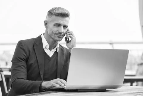 Sales manager talk to client on mobile phone using computer technology for Stock Photos