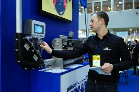 Sales manager touching control panel of a feed transportation system, used in Stock Photos