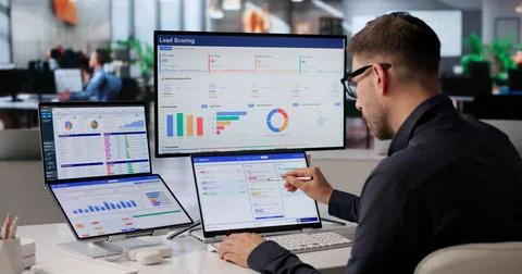Sales Manager Uses Dual Touchscreen Laptop To Track Leads Efficiently. Stock Photos