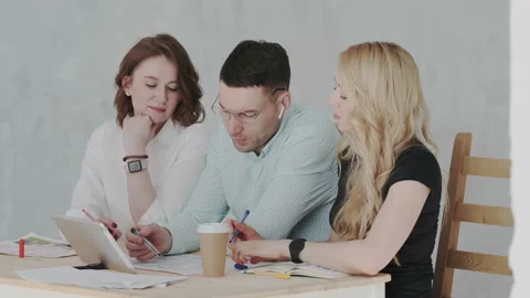 Sales managers discuss the impact of new technologies on the market using tablet Stock Footage 106200260