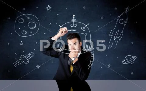Sales person drawing helmet and space rocket Stock Photos