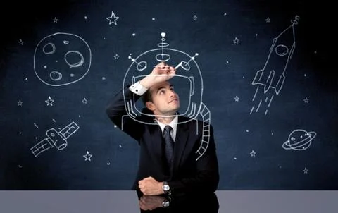 Sales person drawing helmet and space rocket Stock Photos
