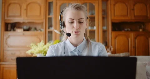 Sales representative in headset speaking to client and making video conference Stock Footage 127304783