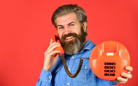 Sales script. Bearded man phone conversation. Retro phone. Outdated technology Stock Photos