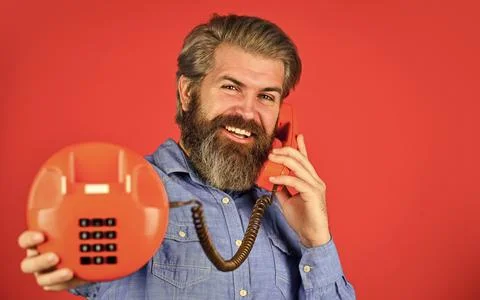 Sales script. Bearded man phone conversation. Retro phone. Outdated technology Stock Photos