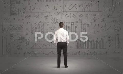 Salesman with business charts on wall Stock Photos