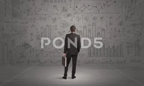 Salesman with business charts on wall Stock Photos