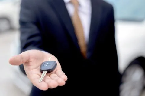 Salesman is carrying the car keys Stock Photos