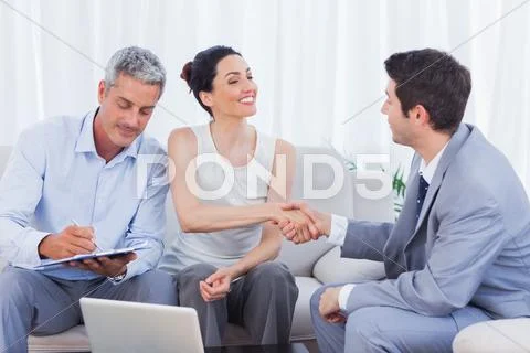 Salesman closing a deal with a couple Stock Photos