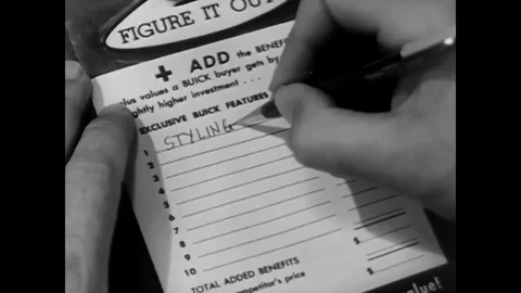 A salesman goes over features and makes notes as he tries to sell a car to a Stock Footage 88555302