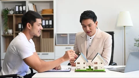 Salesman Hands On House Model , Small Toy House Small Mortgage Property ins.. Stock Footage 312980813