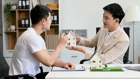 Salesman Hands On House Model , Small Toy House Small Mortgage Property ins.. Stock Footage 312980820