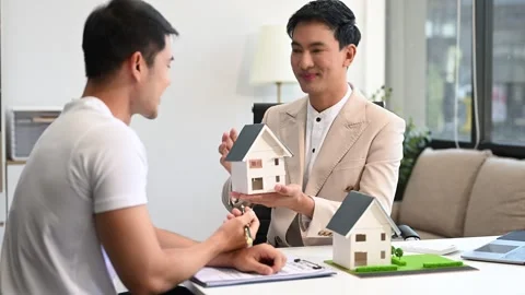 Salesman Hands On House Model , Small Toy House Small Mortgage Property ins.. Stock Footage 312980824