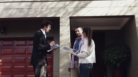 Salesman selling solar panel to young couple home owners to save power or electr Stock-Footage 199631245