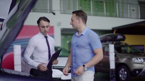 Salesman shows engine for client. Stock Footage 92663752