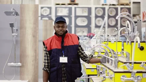 Salesman standing between rows in household hypermarket, looking to the camera Stock Footage 171657368