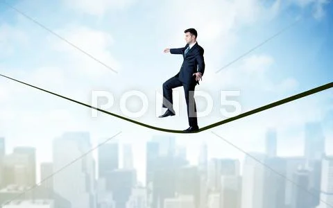 Salesman walking on rope above the city Stock Photos