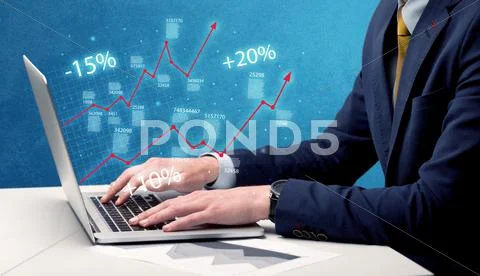 Salesman working on graph with laptop Stock Photos