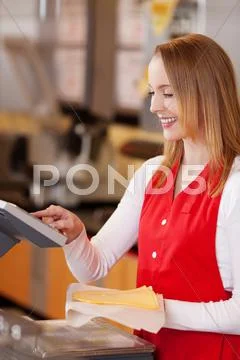 Saleswoman preparing cheese bill at grocery counter Stock Photos